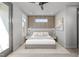 Modern bedroom featuring a wood slat accent wall and neutral color palette, creating a serene atmosphere at 228 Woodsborough Pl, Raleigh, NC 27601