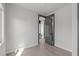 Neutral bedroom featuring hardwood floors, ample lighting, and an open doorway to the bathroom at 228 Woodsborough Pl, Raleigh, NC 27601