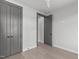 This bedroom has light colored hardwood floors, ceiling fan, and large closet at 228 Woodsborough Pl, Raleigh, NC 27601