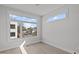 Bright bedroom with large windows offering an outside view and hardwood floors at 228 Woodsborough Pl, Raleigh, NC 27601