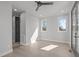 Bright bedroom with hardwood floors, ceiling fan, and access to a balcony through modern glass doors at 228 Woodsborough Pl, Raleigh, NC 27601