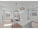 Kitchen island with white marble countertop, stainless steel appliances, and hardwood flooring at 228 Woodsborough Pl, Raleigh, NC 27601