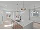 Bright kitchen island with seating, perfect for cooking and casual dining with views into the living area at 228 Woodsborough Pl, Raleigh, NC 27601