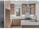 Bright kitchen featuring shaker cabinets, stainless appliances, and white quartz countertops at 228 Woodsborough Pl, Raleigh, NC 27601