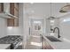 Modern kitchen featuring stainless steel appliances and white countertops, seamlessly connecting to the living area at 228 Woodsborough Pl, Raleigh, NC 27601