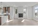 Spacious living room featuring a modern fireplace, seamlessly connected to the kitchen and dining area at 228 Woodsborough Pl, Raleigh, NC 27601