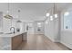 Spacious living room with hardwood floors and modern lighting fixtures, offering an open and airy feel at 228 Woodsborough Pl, Raleigh, NC 27601