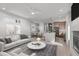 Open-concept living room with hardwood floors, modern furniture, and ample natural light at 228 Woodsborough Pl, Raleigh, NC 27601