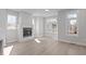 Bright living room with large windows and a modern fireplace, creating an inviting and comfortable space at 228 Woodsborough Pl, Raleigh, NC 27601