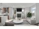 Bright living room with fireplace, hardwood floors, and ample natural light at 228 Woodsborough Pl, Raleigh, NC 27601