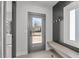 Mudroom boasts storage with bench, hooks and natural light from the window and glass door at 228 Woodsborough Pl, Raleigh, NC 27601