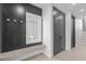 Mudroom complete with hooks, a bench, and a closet with dark accents against a white backdrop at 228 Woodsborough Pl, Raleigh, NC 27601