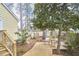 Spacious backyard with a wooden deck, mature trees, and a peaceful seating area at 2618 Elgin St, Durham, NC 27704