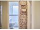 Unique bathroom design with exposed brick, a framed art piece, and a view of the shower at 2618 Elgin St, Durham, NC 27704