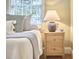 Bright bedroom featuring a wooden nightstand with a stylish lamp and tasteful decor at 2618 Elgin St, Durham, NC 27704