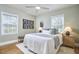Inviting bedroom with a plush bed, neutral tones, and ample natural light from surrounding windows at 2618 Elgin St, Durham, NC 27704
