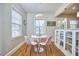 Inviting dining area with modern lighting, a round table, and chic pink chairs near bright windows at 2618 Elgin St, Durham, NC 27704