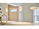 Cozy entryway features modern lighting, neutral tones, and a view of the front yard at 2618 Elgin St, Durham, NC 27704