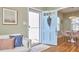 Inviting entryway with an open door and hardwood floors, complemented by stylish seating and decor at 2618 Elgin St, Durham, NC 27704