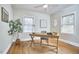 Bright home office featuring a wooden desk, hardwood floors, and ample natural light at 2618 Elgin St, Durham, NC 27704