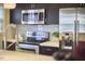 Sleek kitchen featuring stainless steel appliances, dark cabinetry, and a neutral-toned backsplash at 2618 Elgin St, Durham, NC 27704