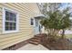 Charming side entrance with brick steps, light blue door, and well-maintained yellow siding at 2618 Elgin St, Durham, NC 27704