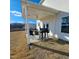 Covered back porch featuring a grill, seating, and view of the backyard and trees at 265 Forest Meadow Ln, Franklinton, NC 27525