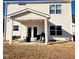 Backyard featuring a covered patio with outdoor furniture, grill, and view of the grassy lawn at 265 Forest Meadow Ln, Franklinton, NC 27525