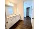 Bright bathroom featuring double vanity sinks and wood-look floors at 265 Forest Meadow Ln, Franklinton, NC 27525