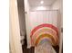 Cozy bathroom featuring a toilet and tub with a rainbow shower curtain at 265 Forest Meadow Ln, Franklinton, NC 27525