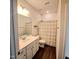 Bathroom featuring a white vanity, large mirror, and a shower with a neutral colored shower curtain at 265 Forest Meadow Ln, Franklinton, NC 27525