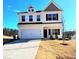 Charming two-story home with a two car garage and a well-manicured lawn under a clear blue sky at 265 Forest Meadow Ln, Franklinton, NC 27525