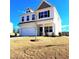 Beautiful two-story home featuring a two car garage, well-maintained lawn, and a bright, sunny sky at 265 Forest Meadow Ln, Franklinton, NC 27525