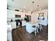 Well-lit kitchen with stainless steel appliances, granite counters and white cabinets with dark wood flooring at 265 Forest Meadow Ln, Franklinton, NC 27525