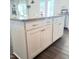 White kitchen island featuring granite countertops, storage cabinets and stylish hardware at 265 Forest Meadow Ln, Franklinton, NC 27525