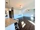 Open concept living and dining area with modern dark wood flooring and staircase at 265 Forest Meadow Ln, Franklinton, NC 27525