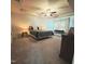 Spacious main bedroom with large windows, a ceiling fan, and a cozy bed at 265 Forest Meadow Ln, Franklinton, NC 27525