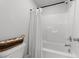 Bathroom featuring a toilet next to a shower with a white shower curtain and toilet paper at 283 Dry Canyon Dr, Wendell, NC 27591