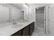 Modern bathroom featuring double vanity with white countertop and dark cabinets, with separate tub and toilet area at 283 Dry Canyon Dr, Wendell, NC 27591