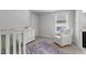 Cozy Bedroom area with a crib, dresser, and comfortable rocking chair, designed for relaxation and care at 283 Dry Canyon Dr, Wendell, NC 27591