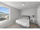 Cozy bedroom featuring a comfortable bed, stylish side table, and a scenic view from the window at 283 Dry Canyon Dr, Wendell, NC 27591