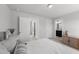 A bedroom with neutral tones and a large bed leading to the closet and bathroom at 283 Dry Canyon Dr, Wendell, NC 27591