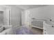 Bright Bedroom featuring a crib, plush chair, and a patterned area rug, perfect for a calming space at 283 Dry Canyon Dr, Wendell, NC 27591
