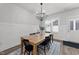 Dining room with wood table, chandelier, rug and paneled accent wall at 283 Dry Canyon Dr, Wendell, NC 27591