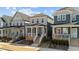 Stylish new construction home featuring a charming front porch, modern color palette, and well-manicured landscaping at 283 Dry Canyon Dr, Wendell, NC 27591