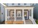 Inviting front porch with white columns, wood accents, and a stylish entrance door, enhancing curb appeal at 283 Dry Canyon Dr, Wendell, NC 27591