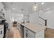 Modern kitchen with stainless steel appliances, granite countertops, and an island with pendant lighting at 283 Dry Canyon Dr, Wendell, NC 27591