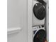 Efficient laundry area featuring a stacked washer and dryer unit, optimizing space and convenience at 283 Dry Canyon Dr, Wendell, NC 27591