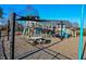 Community playground features a wooden climbing structure, slide, and picnic table at 283 Dry Canyon Dr, Wendell, NC 27591