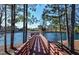Picturesque pond view with a wooden pier, offering serene natural scenery at 283 Dry Canyon Dr, Wendell, NC 27591